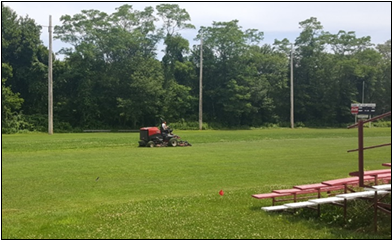 Person mowing athletic field